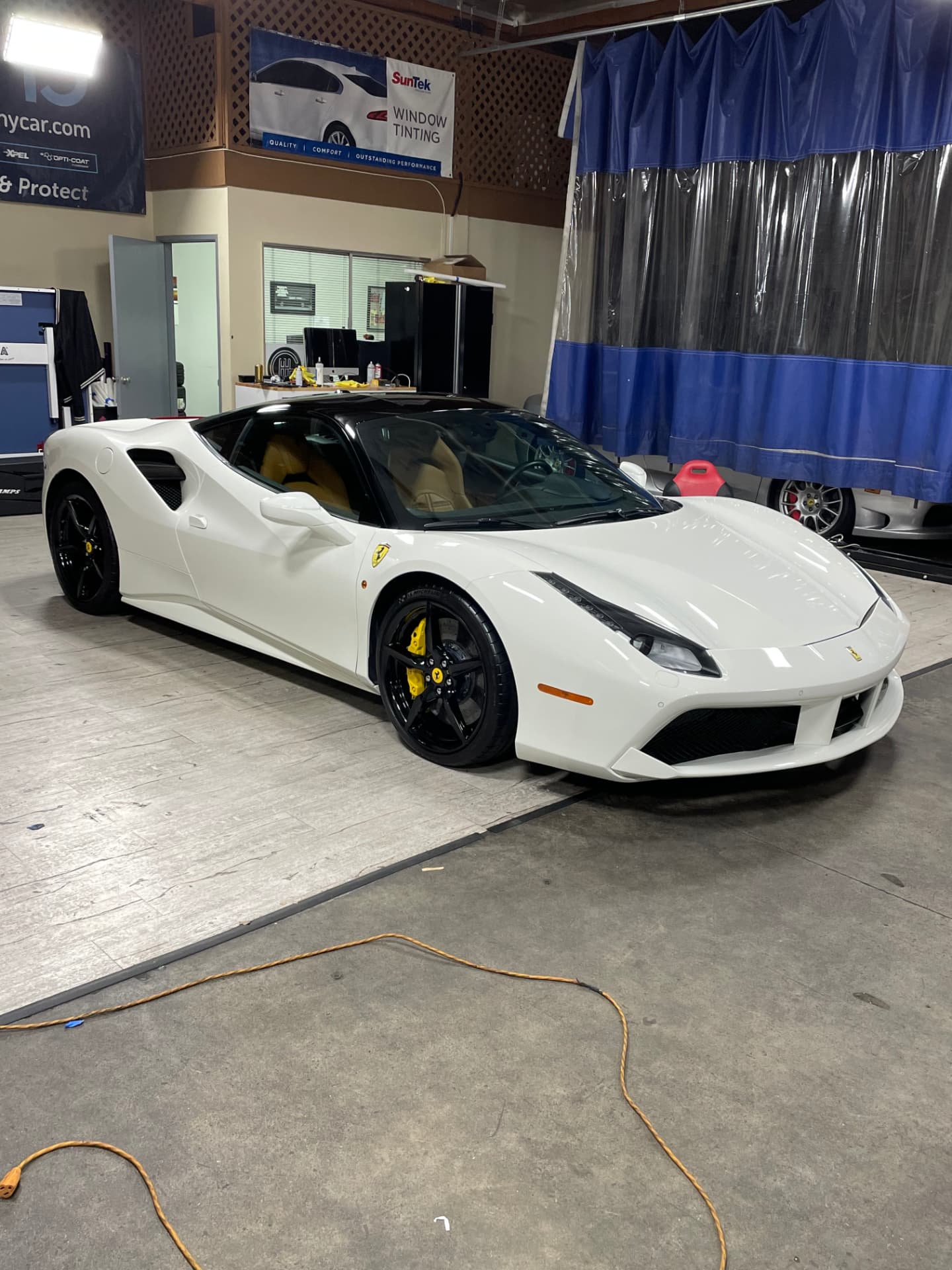 White Ferrari 488 with black roof after detailing